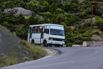 Bus move along a winding mountain road