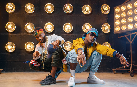 Two black rappers sitting on the floor