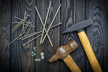 Tools for carpentry and accessories on a black wood background.