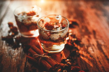 Two cups of loose leaf tea on a wooden table, top view