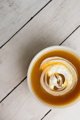 Pumpkin soup with sour cream in white small bowl 