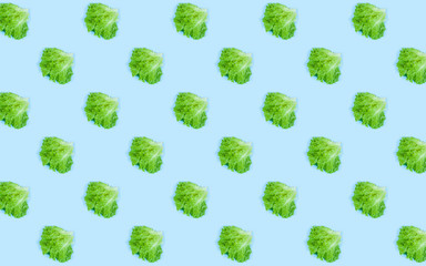 Pattern of fresh Green lettuce on blue background. Top view. Summer concept. Collage