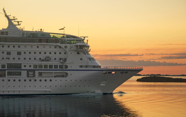 Passenger ferry against a sunset in the Baltic sea.