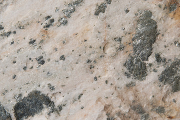 Stone texture and background. Rough natural rock with silver colored minerals in the stone.