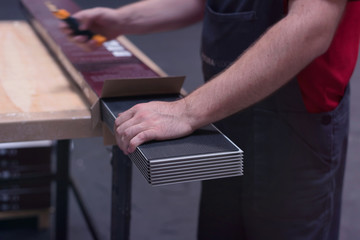 Worker in his carpenter workshop standing proud in front of the machines of the factory floor. Carpenter factory working.