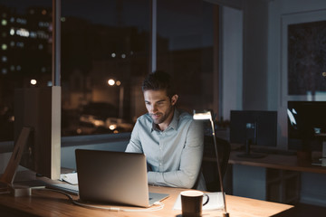 Young businessman working late at night in an office