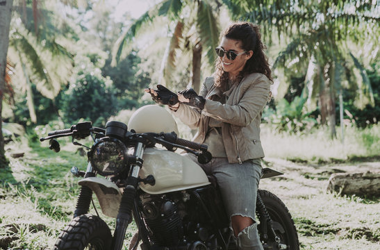 beautiful woman making a jungle tour with her motorcycle