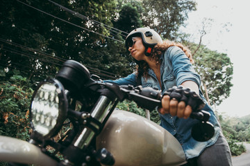 Fototapeta premium beautiful woman making a jungle tour with her motorcycle