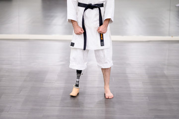 Karate man with prosthetic leg prepared for combat