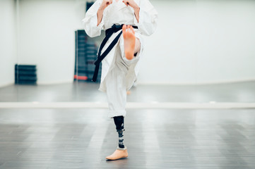 Man with prosthetic leg practicing karate