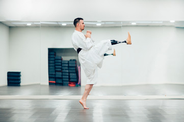 Man with prosthetic leg practicing karate