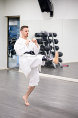 Man with prosthetic leg practicing karate