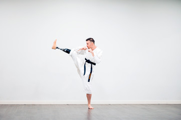Man with prosthetic leg practicing karate