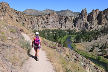 Young woman on Misery Ridge Trail in Smith Rock State Park near Terrebonne, Oregon on a coudless...