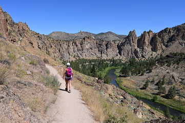 Young woman on Misery Ridge Trail in Smith Rock State Park near Terrebonne, Oregon on a coudless...