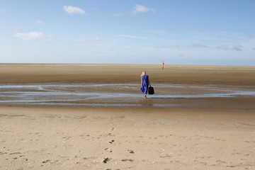 woman walks away on beach