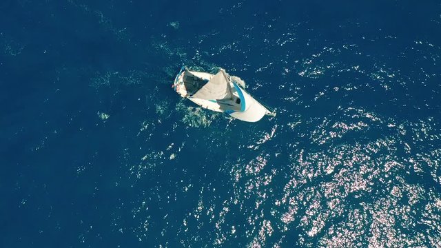 Aerial view. Yacht sailing on open sea at sunny day. Sailing boat.