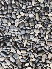 Beautiful grey, blue and white rocks and stones. Beautiful texture and pattern. Neutral background. Top view, flat lay.