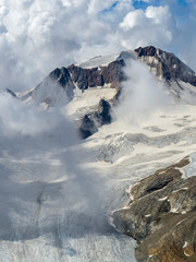 Fototapeta na wymiar Mountain top view of Glacier Senales partly covered in clouds