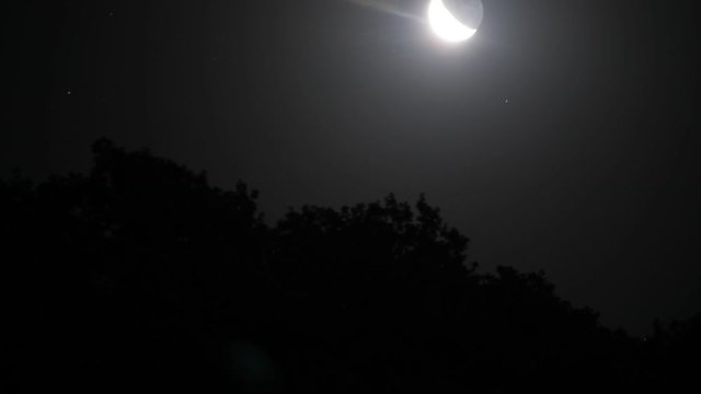 Time lapse with rising moon over a mountain at night. Nature shot