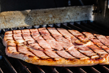 Ham steak on the grill. Calgary, Alberta, Canada
