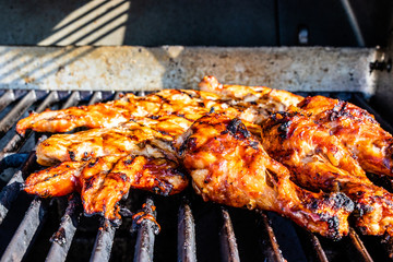 BBQ sauced Chicken legs and breasts on the grill. Calgary, Alberta, Canada