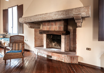 Rustic brick fireplace with wooden beams.