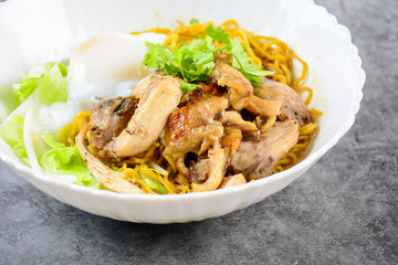 Egg noodles served dry with roasted honey chicken and soft-boiled eggs (onsen tamago eggs)