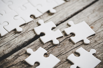 A close up view of several white jigsaw puzzle pieces