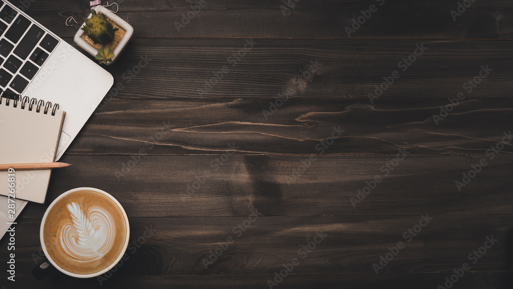 Aufkleber modern dark wood office desk table with laptop, smartphone and other supplies with cup of coffee. co