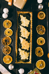 Freshly baked chrismtas tart  on a wooden background with various christmas decoration