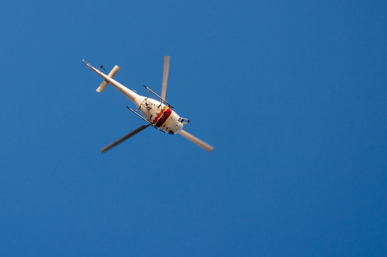 Helicopter commercial  in flight on background of blue sky