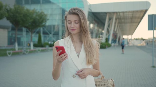 Bonus Footage 2 of 1. Portrait Young Attractive Smile Woman Look at Camera at city center feel happy + Close up of a Woman's hand holding a Mobile Telephone with a Vertical Green Screen Smartphone