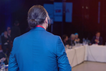 Businessman at business conference room with public giving presentations. Audience at the...