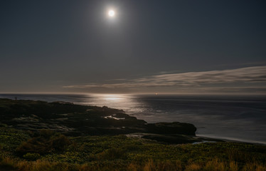 Full moon over the Pacific Ocean shore, Yachats Oregon