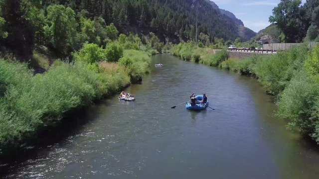 Following a river raft downstream in the Provo River in Utah