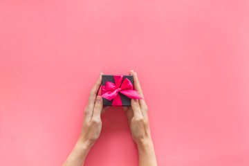 gifts in hands on pink background top view mockup
