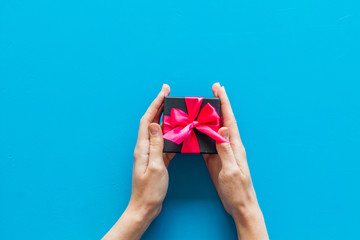 gifts in hands on blue background top view mockup