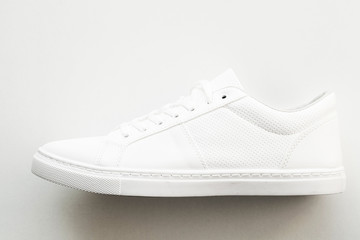 Stylish white fashion sneakers on white background.