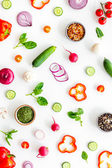 Sliced, cut, chopped vegetables pattern on white background top view
