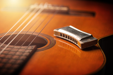 Fototapeta na wymiar vintage harmonica on acoustic guitar