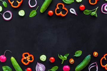 Frame of colorful vegetables on black background top view mock up