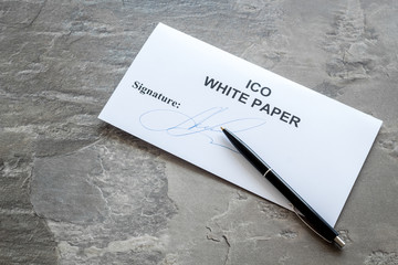 White paper ICO, pen on gray textured background