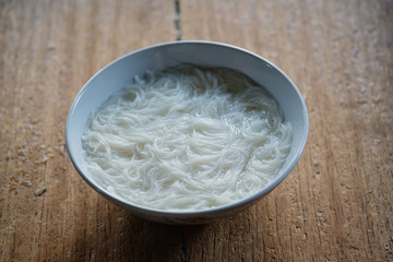 White noodle in bowl on  wooden table