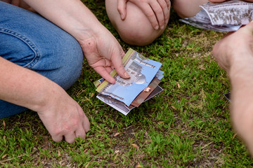 people play a game with cards on the grass in the garden