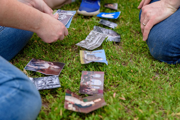 people play a game with cards on the grass in the park zone