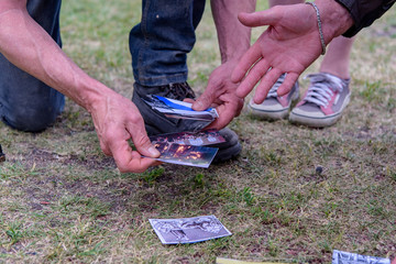 people play a game with cards on the grass in the garden