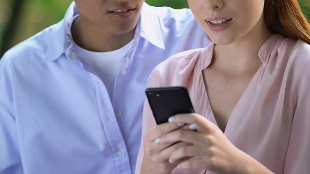 Girl reading secret messages in phone, boyfriend lying, making excuses, cheating