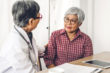 Fototapeta premium Doctor consulting and check up information with senior woman in hospital.elderly woman has sick.healthcare and medicine