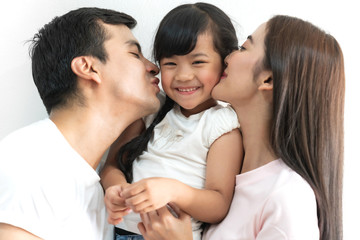 Obraz premium Portrait of happy family father and mother with daughter on white background